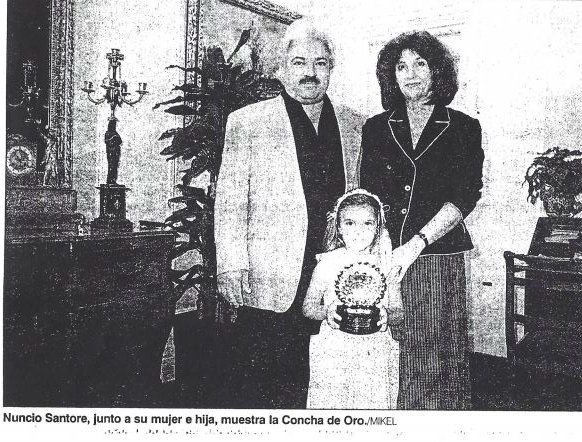 Rotated newspaper print of Nunzio Santore with his wife and daughter, who holds the Concha de Oro trophy
